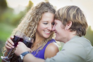 An Attractive Couple Enjoying A Glass Of Wine in the Park Together.